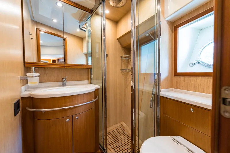 Jasmine 3 Yacht Photos Pics Luxurious bathroom interior of 2011 Apreamare Maestro 65 yacht with wood accents and modern fixtures.