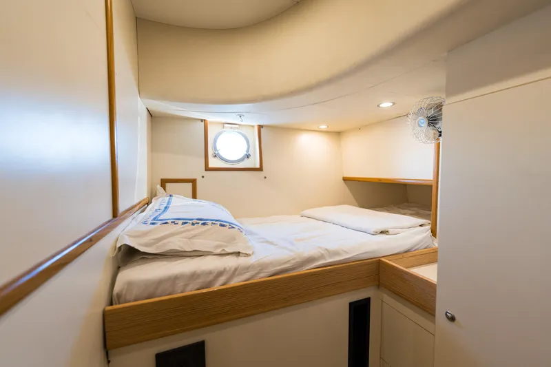 Jasmine 3 Yacht Photos Pics Cozy cabin interior of 2011 Apreamare Maestro 65 yacht with bed and porthole window.