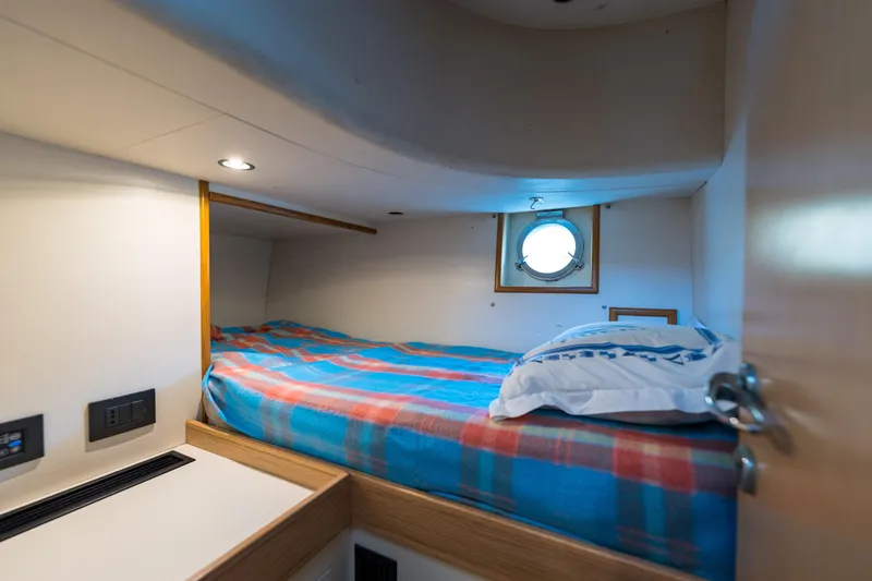 Jasmine 3 Yacht Photos Pics Cozy cabin interior of 2011 Apreamare Maestro 65 yacht with porthole and bed.