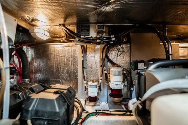 Lunasea Yacht Photos Pics Engine room of 2005 Cruiser Yachts 405 EXPRESS, showcasing mechanical components and wiring.