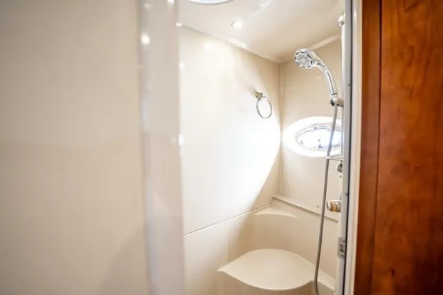 Lunasea Yacht Photos Pics Luxurious bathroom in 2005 Cruiser Yachts 405 EXPRESS with modern shower and porthole window.
