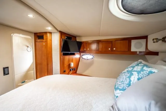 Lunasea Yacht Photos Pics Luxurious cabin interior of 2005 Cruiser Yachts 405 EXPRESS with wood accents and cozy bedding.