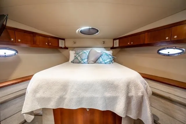 Lunasea Yacht Photos Pics Luxurious cabin interior of 2005 Cruiser Yachts 405 EXPRESS with cozy bed and elegant wood finish.