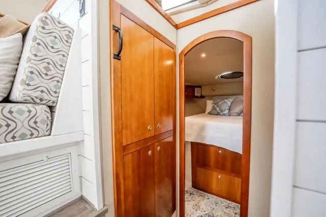 Lunasea Yacht Photos Pics 2005 Cruiser Yachts 405 EXPRESS cabin interior with wood cabinetry and cozy sleeping area.