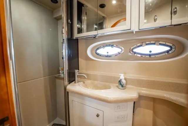 Lunasea Yacht Photos Pics Luxurious bathroom in 2005 Cruiser Yachts 405 EXPRESS with oval windows and modern fixtures.