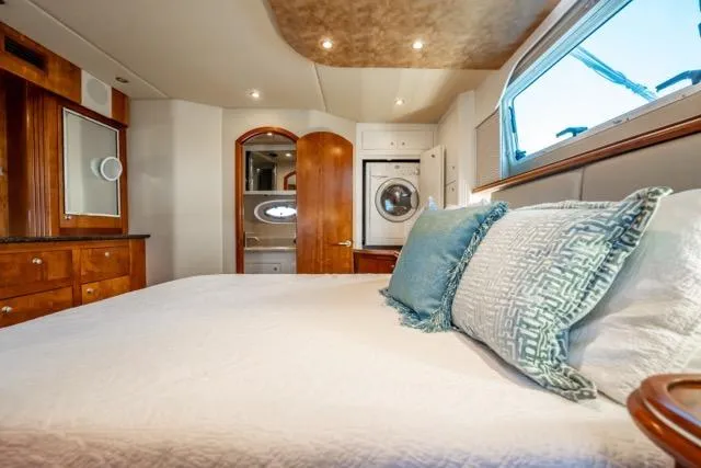 Lunasea Yacht Photos Pics Luxurious bedroom interior of 2005 Cruiser Yachts 405 EXPRESS with elegant bedding and wood accents.