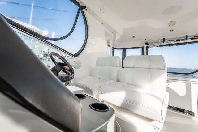 Lunasea Yacht Photos Pics 2005 Cruiser Yachts 405 EXPRESS interior with white seating and steering wheel.