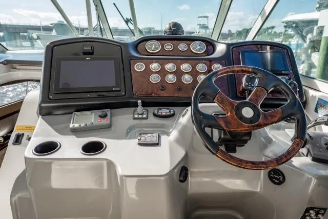 Lunasea Yacht Photos Pics Helm of 2005 Cruiser Yachts 405 EXPRESS with modern navigation controls and steering wheel.