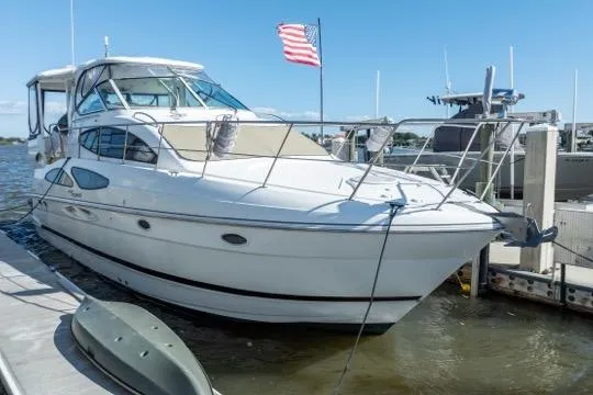 Lunasea Yacht Photos Pics 2005 Cruiser Yachts 405 EXPRESS docked, featuring sleek design and American flag.