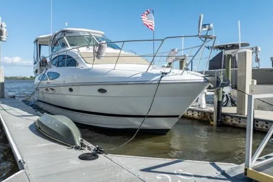 Lunasea Yacht Photos Pics 2005 Cruiser Yachts 405 EXPRESS docked, featuring sleek design and American flag.