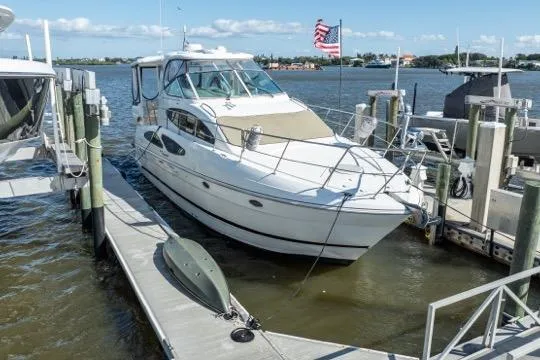 Lunasea Yacht Photos Pics 2005 Cruiser Yachts 405 EXPRESS docked at marina with American flag in background.