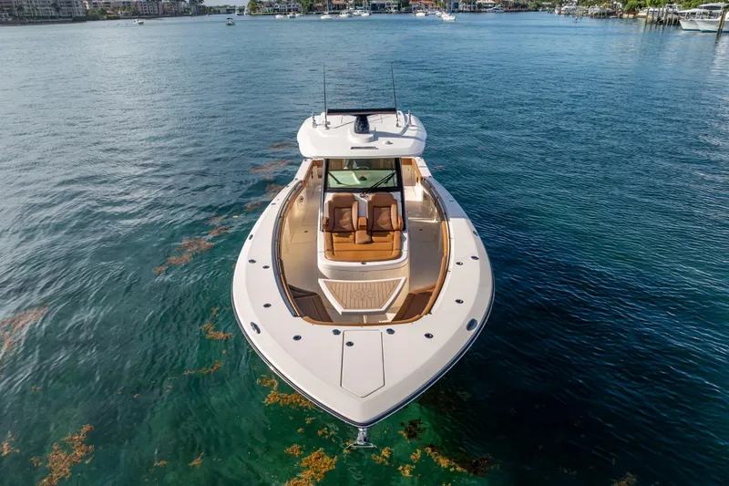  Yacht Photos Pics 2021 Scout 380 LXF boat on calm water, showcasing sleek design and luxury features.