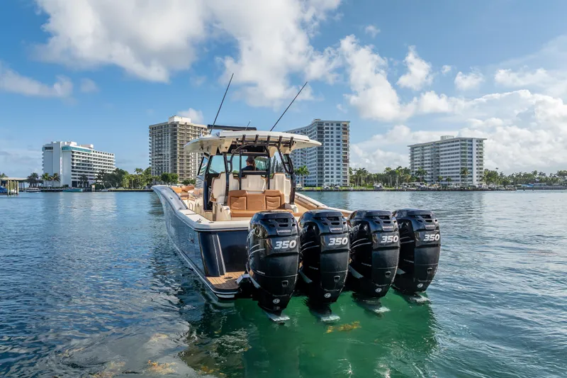  Yacht Photos Pics 2021 Scout 380 LXF boat with four engines on water, cityscape background.