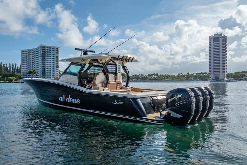  Yacht Photos Pics 2021 Scout 380 LXF boat with four Mercury engines on a sunny waterfront.