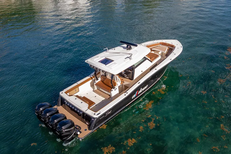  Yacht Photos Pics 2021 Scout 380 LXF luxury boat on clear water, featuring triple outboard engines.