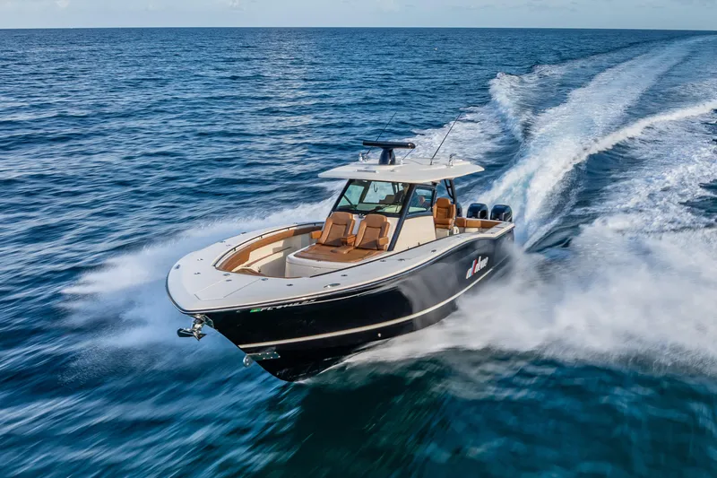  Yacht Photos Pics 2021 Scout 380 LXF boat cruising swiftly on open ocean waters.