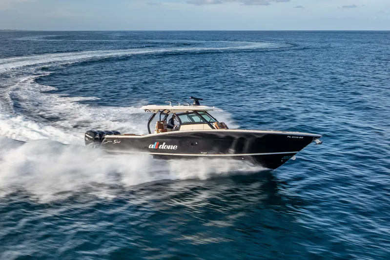  Yacht Photos Pics 2021 Scout 380 LXF boat cruising swiftly on open water.