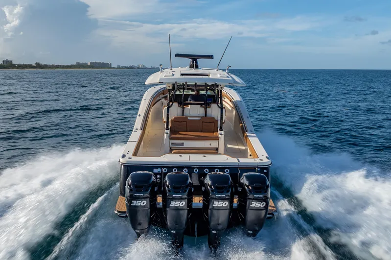 Yacht Photos Pics 2021 Scout 380 LXF boat cruising on open water with four powerful engines.
