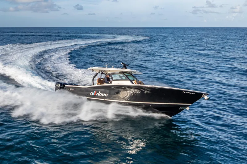  Yacht Photos Pics 2021 Scout 380 LXF boat cruising swiftly on open ocean waters.