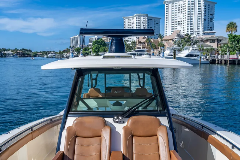  Yacht Photos Pics 2021 Scout 380 LXF boat on water with city skyline in background.