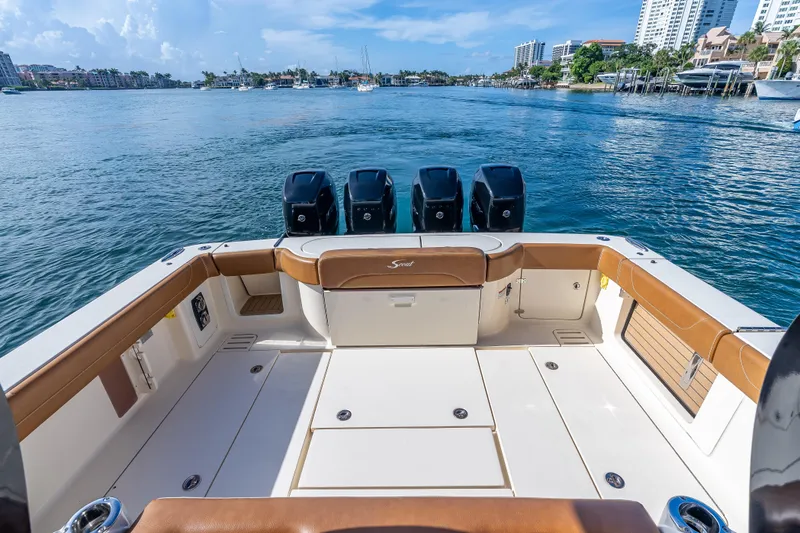  Yacht Photos Pics 2021 Scout 380 LXF boat deck with four engines, cruising on a scenic waterway.
