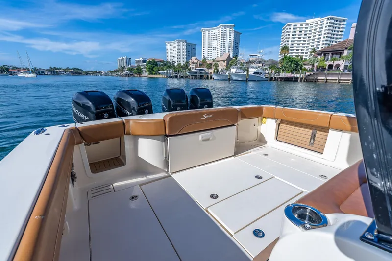  Yacht Photos Pics 2021 Scout 380 LXF boat interior with Mercury engines, docked near waterfront buildings.