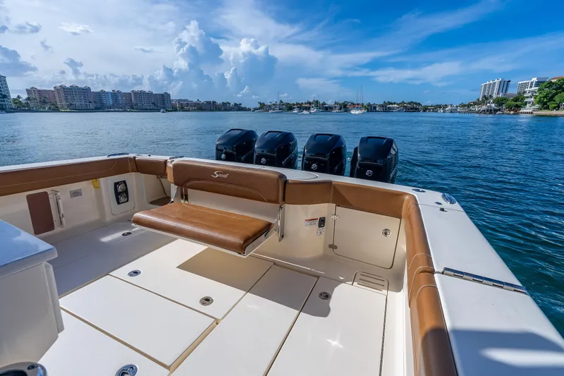  Yacht Photos Pics 2021 Scout 380 LXF boat with quad engines on a sunny waterfront.