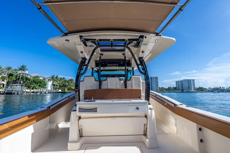  Yacht Photos Pics 2021 Scout 380 LXF boat on water, featuring sleek design and luxurious seating.