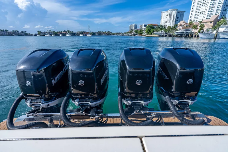  Yacht Photos Pics 2021 Scout 380 LXF with four powerful Mercury outboard engines on a sunny waterfront.