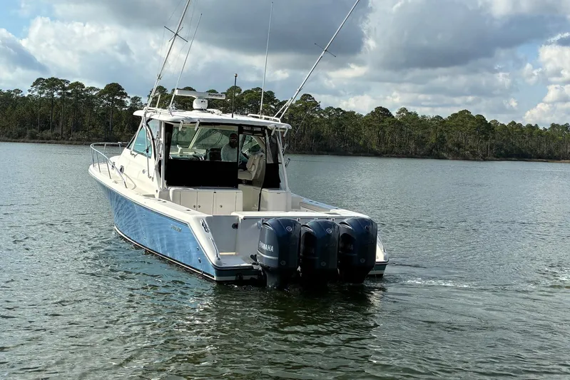 Pescador Yacht Photos Pics 2011 Pursuit OS 375 Offshore boat with triple Yamaha engines on a calm lake.