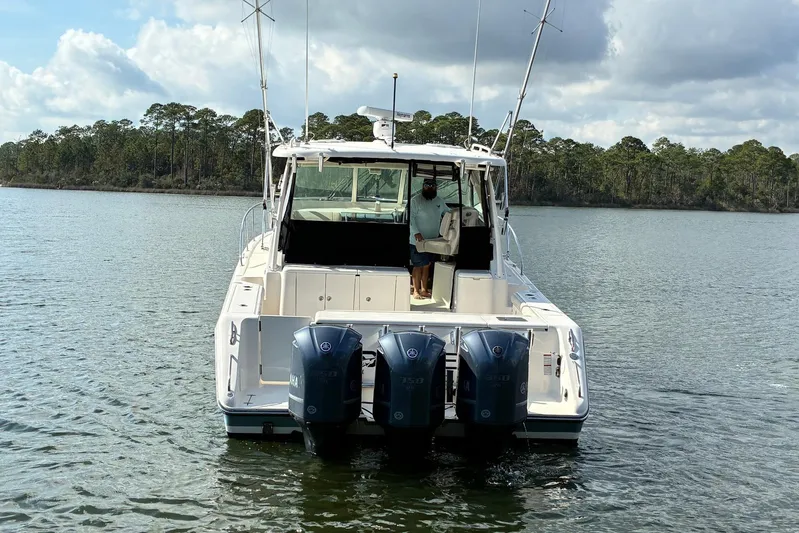 Pescador Yacht Photos Pics 2011 Pursuit OS 375 Offshore boat with triple outboard engines on a calm lake.