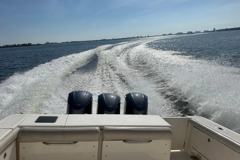 Pescador Yacht Photos Pics 2011 Pursuit OS 375 Offshore boat cruising, leaving a wake on a sunny day.