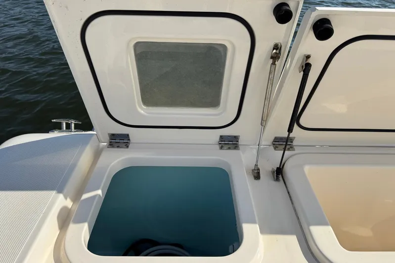 Pescador Yacht Photos Pics Open storage compartments on a 2011 Pursuit OS 375 Offshore boat, near water.