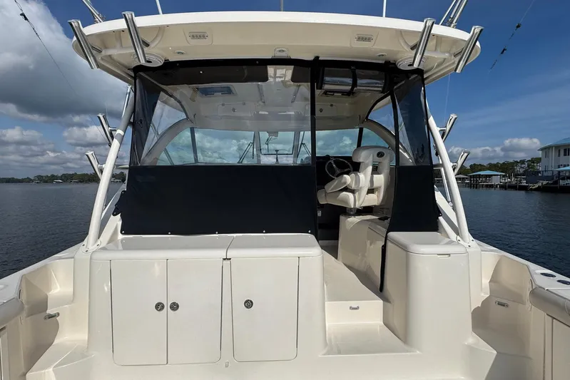 Pescador Yacht Photos Pics 2011 Pursuit OS 375 Offshore boat interior with helm and seating, dockside view.