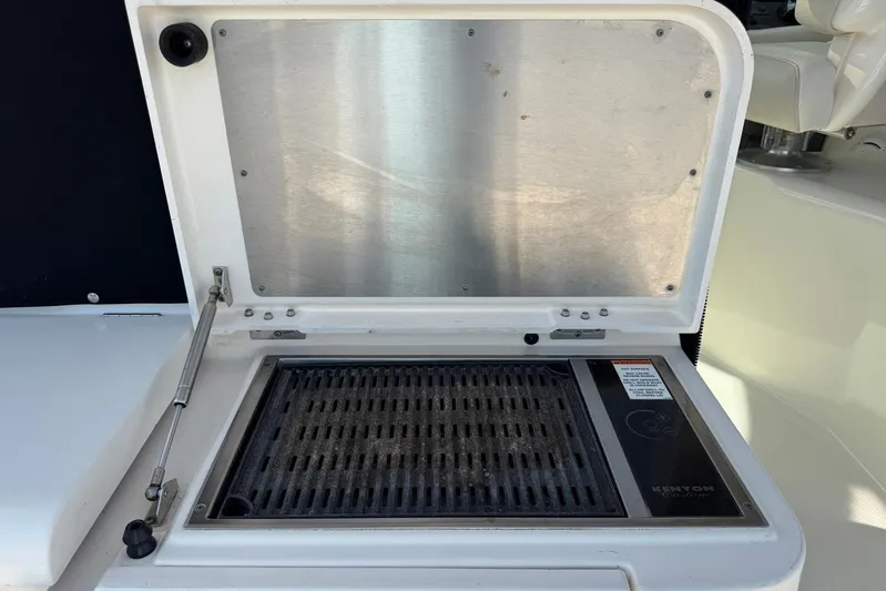 Pescador Yacht Photos Pics Outdoor grill on 2011 Pursuit OS 375 Offshore boat, featuring Kenyon electric cooktop.