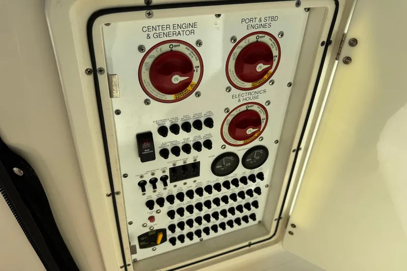 Pescador Yacht Photos Pics Control panel of a 2011 Pursuit OS 375 Offshore boat, featuring engine and electronics switches.