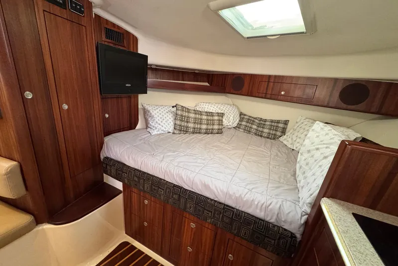 Pescador Yacht Photos Pics 2011 Pursuit OS 375 Offshore cabin with cozy bed and wooden interior.