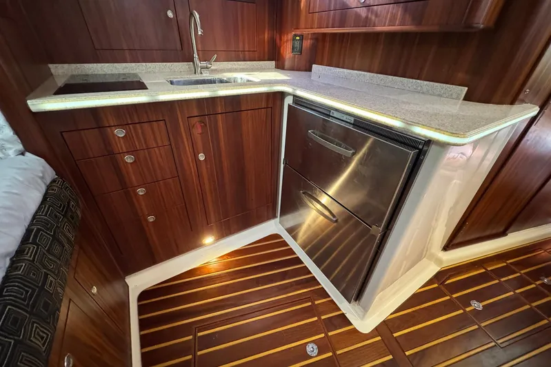 Pescador Yacht Photos Pics 2011 Pursuit OS 375 Offshore yacht kitchen with wood cabinetry and stainless steel appliances.