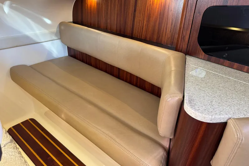 Pescador Yacht Photos Pics Luxurious interior of 2011 Pursuit OS 375 Offshore boat with beige seating and wood accents.