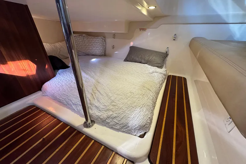 Pescador Yacht Photos Pics Cozy cabin interior of 2011 Pursuit OS 375 Offshore with comfortable bedding.