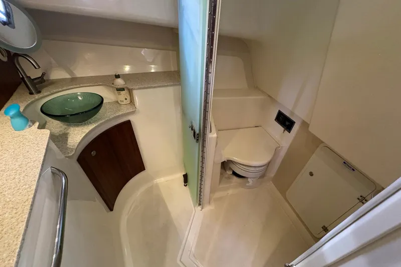 Pescador Yacht Photos Pics 2011 Pursuit OS 375 Offshore boat bathroom with sink, toilet, and storage.