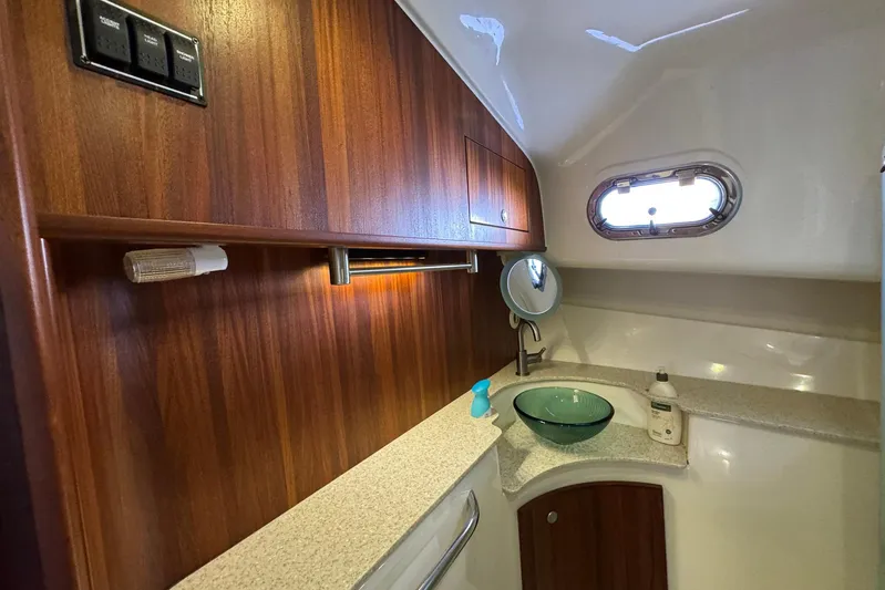 Pescador Yacht Photos Pics 2011 Pursuit OS 375 Offshore yacht bathroom with wood cabinetry and glass sink.