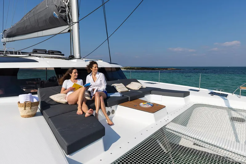 Aura 51 In St.petersburg, Fl. Ex-factory Nov 2025 Yacht Photos Pics 2025 Fountaine Pajot Aura 51 catamaran with two women relaxing on deck.