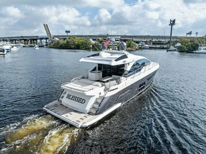 Blessed Yacht Photos Pics 2020 Azimut S6 yacht cruising on a river, displaying the name "Blessed."