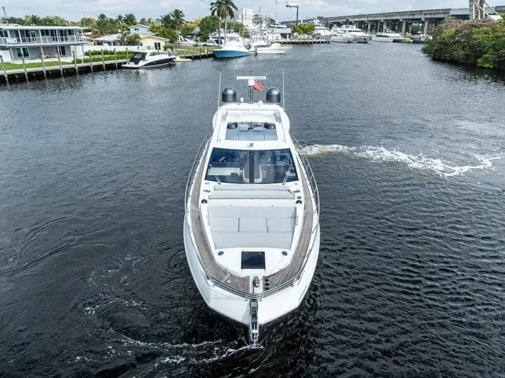 Blessed Yacht Photos Pics 2020 Azimut S6 yacht cruising on a scenic waterway, surrounded by lush greenery and other boats.