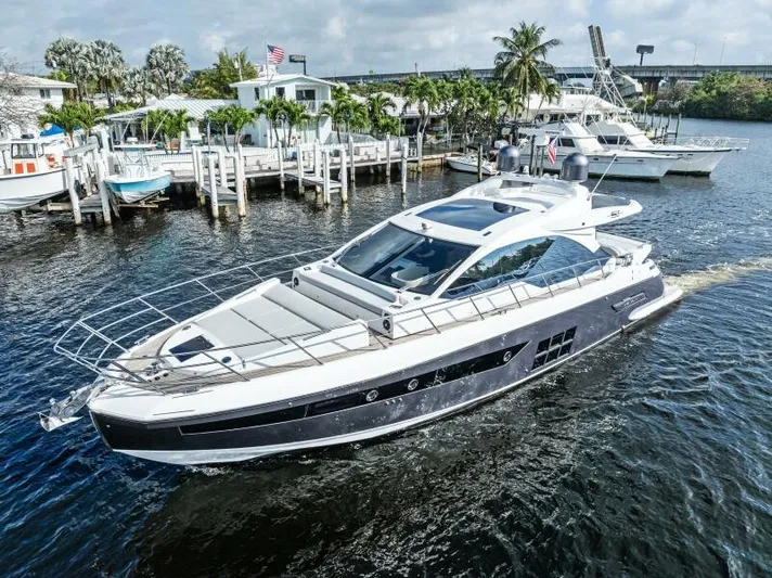 Blessed Yacht Photos Pics Azimut S6 2020 yacht cruising near a marina with palm trees and docks.