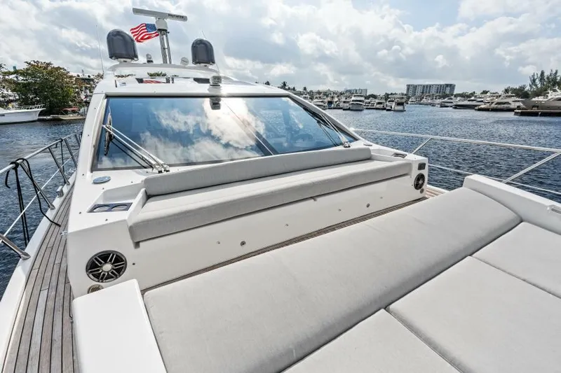 Blessed Yacht Photos Pics 2020 Azimut S6 yacht with sleek design, docked in a marina under a cloudy sky.