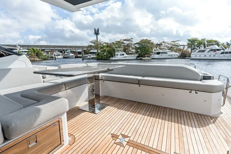 Blessed Yacht Photos Pics Azimut S6 2020 yacht deck with seating and table, overlooking marina.