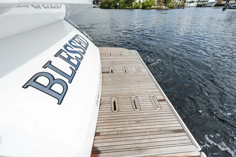 Blessed Yacht Photos Pics 2020 Azimut S6 yacht with "Blessed" on the stern, docked by the water.