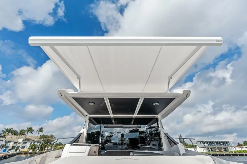 Blessed Yacht Photos Pics 2020 Azimut S6 yacht with extended sunroof under a blue sky.